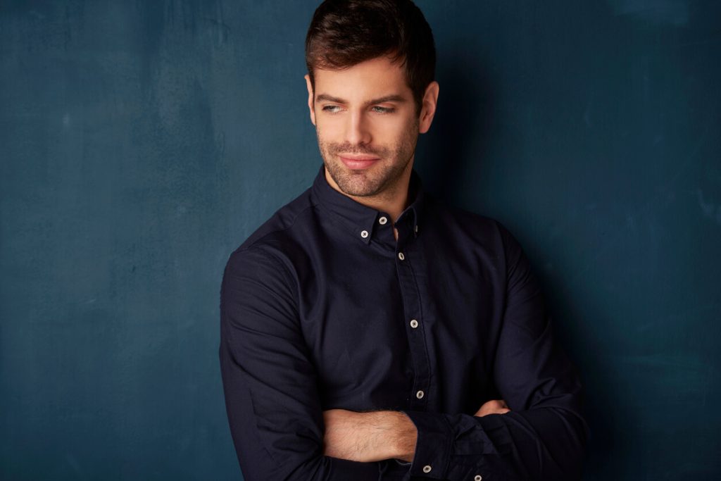 man in dark colored button down shirt