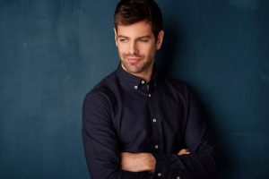 man in dark colored button down shirt